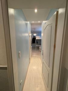 a hallway with a white door and a hallway with a room at Hause münchen comfort! in Munich