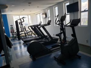 a gym with several tread machines in a room at Apto Hotel Blue Tree Manaus in Manaus