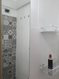 a shower with a glass door with a bottle on a shelf at Tu mejor opción en Mar del Plata. Cerca de todo. in Mar del Plata