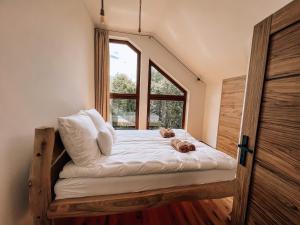 a bed with two teddy bears on it in a room at Marina Olchowiec - Villa in Olchowiec