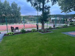 a park with a tree and a soccer field at Mieszkanie - Apartament in Dąbrowa