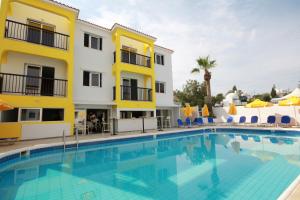 a hotel with a swimming pool in front of a building at Sea CleoNapa Hotel in Ayia Napa