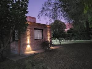 a brick house with lights on the side of it at Apart Picaflores in Merlo