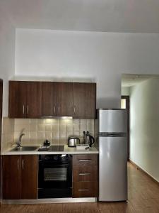 a kitchen with a refrigerator and a sink at Cozy house city center in Limassol in Limassol