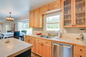 a kitchen with wooden cabinets and a sink at Rockville Home Patio Oasis, Fireplace, Near DC! in Rockville