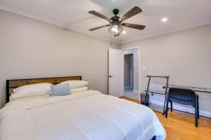 a white bedroom with a bed and a ceiling fan at Rockville Home Patio Oasis, Fireplace, Near DC! in Rockville