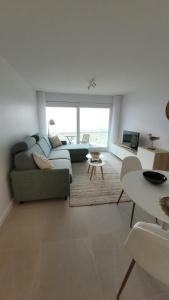 a living room with a couch and a table at Studio Zeezicht by Qua-Lyne in Ostend