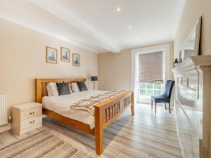a bedroom with a bed and a desk and a chair at The Annexe At Moulton Grange in Brixworth