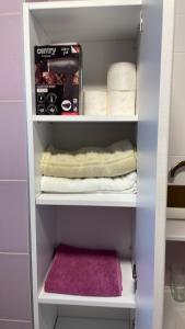 a cupboard with towels and a box in a bathroom at Exclusive apartments Visoko 2022 in Visoko