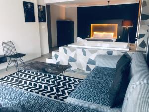 a bedroom with a bed and a table and a couch at 06ev Rental House in Ankara