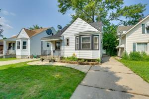 a white house with a lawn in front of it at Pet-Friendly Dearborn Home Less Than 2 Mi to Downtown! in Dearborn