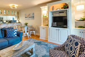 a living room with a couch and a table at Surfside Beach Condo with Ocean Access and Balcony! in Myrtle Beach