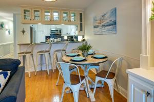 a kitchen and living room with a table and chairs at Surfside Beach Condo with Ocean Access and Balcony! in Myrtle Beach