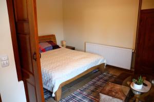 a small bedroom with a bed and a table at Agroturizam OPG Jakopović in Čaglin