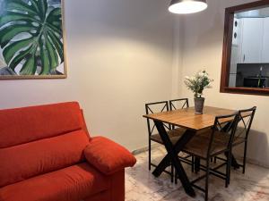 a living room with a table and a couch at Milenium Palace - Garaje incluido - Piscina-FIBES in Seville