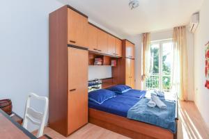 a bedroom with a bed with a large wooden headboard at Vizmeg Holiday Home in Dubrovnik