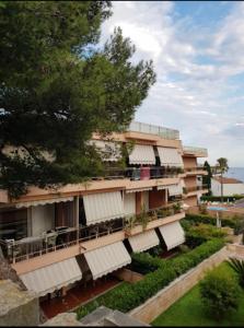 a building with white awnings on the side of it at baiasole in Sanremo