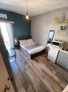 a bedroom with a large bed and a kitchen at Spiros apartment in the center of Preveza Dodonis 32 in Preveza