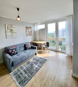 a living room with a couch and a table at City Centre top floor Apartment in Warsaw