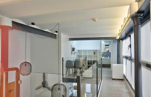 a room with a glass table and a dining room at Duplex moderno en Alameda in Seville