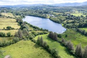 an aerial view of a lake in a field at Bradleys Cottage Creeslough in Creeslough