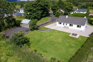 an aerial view of a white house with a yard at Bradleys Cottage Creeslough in Creeslough