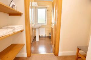 a small bathroom with a sink and a mirror at Bradleys Cottage Creeslough in Creeslough