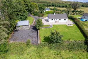 an aerial view of a house with a yard at Bradleys Cottage Creeslough in Creeslough