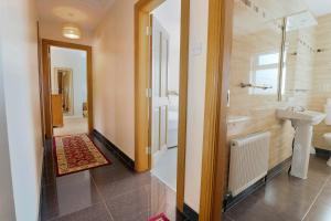 a bathroom with a sink and a shower and a toilet at Bradleys Cottage Creeslough in Creeslough +31 photos