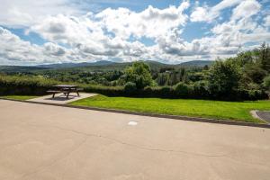 a picnic table in a park with a view at Bradleys Cottage Creeslough in Creeslough