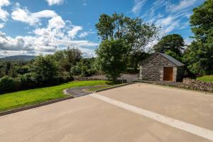 an empty parking lot in front of a stone building at Bradleys Cottage Creeslough in Creeslough
