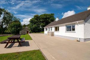 a picnic table in front of a building at Bradleys Cottage Creeslough in Creeslough