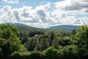 a view of a valley with trees and mountains at Bradleys Cottage Creeslough in Creeslough