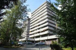 a large building with cars parked in front of it at Ferienwohnung Paula in Bad Harzburg