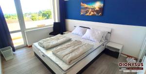 A bed or beds in a room at Arode Villa Dionysus