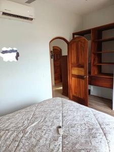 a bedroom with a bed and a wooden cabinet at “Casa Juanita” in Lo de Marcos