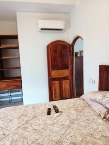 a bedroom with a bed with two remote controls on it at “Casa Juanita” in Lo de Marcos