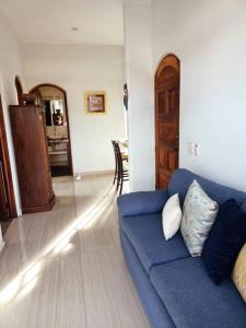 a living room with a blue couch and a table at “Casa Juanita” in Lo de Marcos