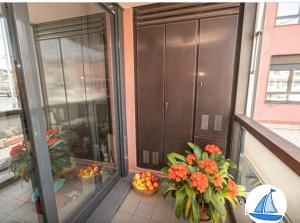 a balcony with orange flowers and a basket of fruit at APPARTAMENTO SUL MARE KATE in Genoa