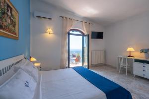 a bedroom with a bed and a view of the ocean at Villa di lusso con piscina tra Positano e Amalfi in Conca dei Marini +62 photos