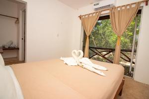 Postel nebo postele na pokoji v ubytování Hotel Ak'Na Holbox