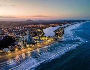 an aerial view of the beach at night at Mar com Diversão in Barra Velha +4 photos
