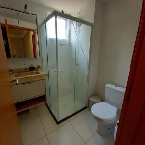 a bathroom with a shower and a toilet and a sink at Mar com Diversão in Barra Velha