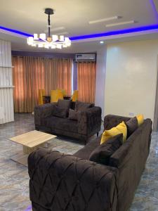 a living room with two couches and a table at Bamod Hotel and Suites in Lekki