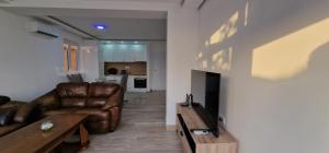 a living room with a couch and a table at Apartman Haris in Dobra Voda