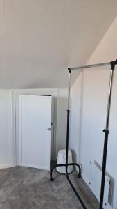 a white room with a white door and a toilet at Cosey 1 bedroom loft with free parking in Stavanger