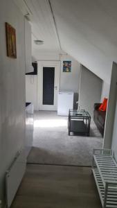 a living room with a couch and a table at Cosey 1 bedroom loft with free parking in Stavanger