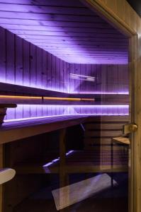 a piano with purple lights in a room at Apartament Żubry z Sauna in Zakopane