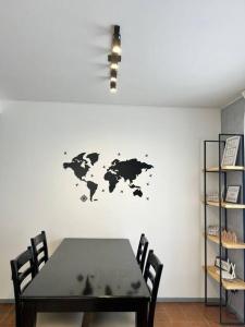 uma mesa de jantar com um mapa do mundo na parede em Exclusive Urban Apartment em Mendoza