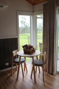 a table and chairs with a basket on top of it at Little Sherwood Drouin Petting Zoo & Cottages in Drouin West